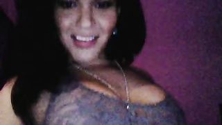 Smiling tanned transsexual looks great in the doggy style pose